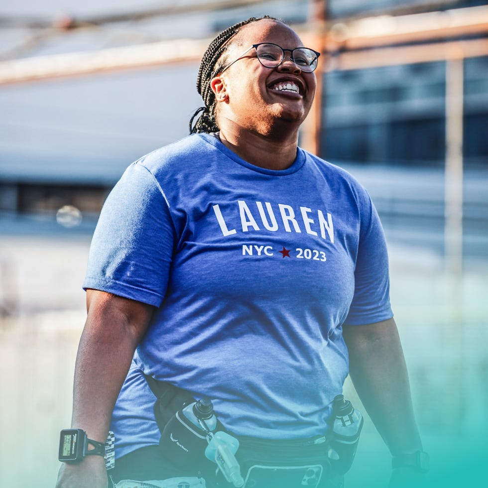 person wearing a blue tshirt with lauren nyc 2023 text standing outdoor