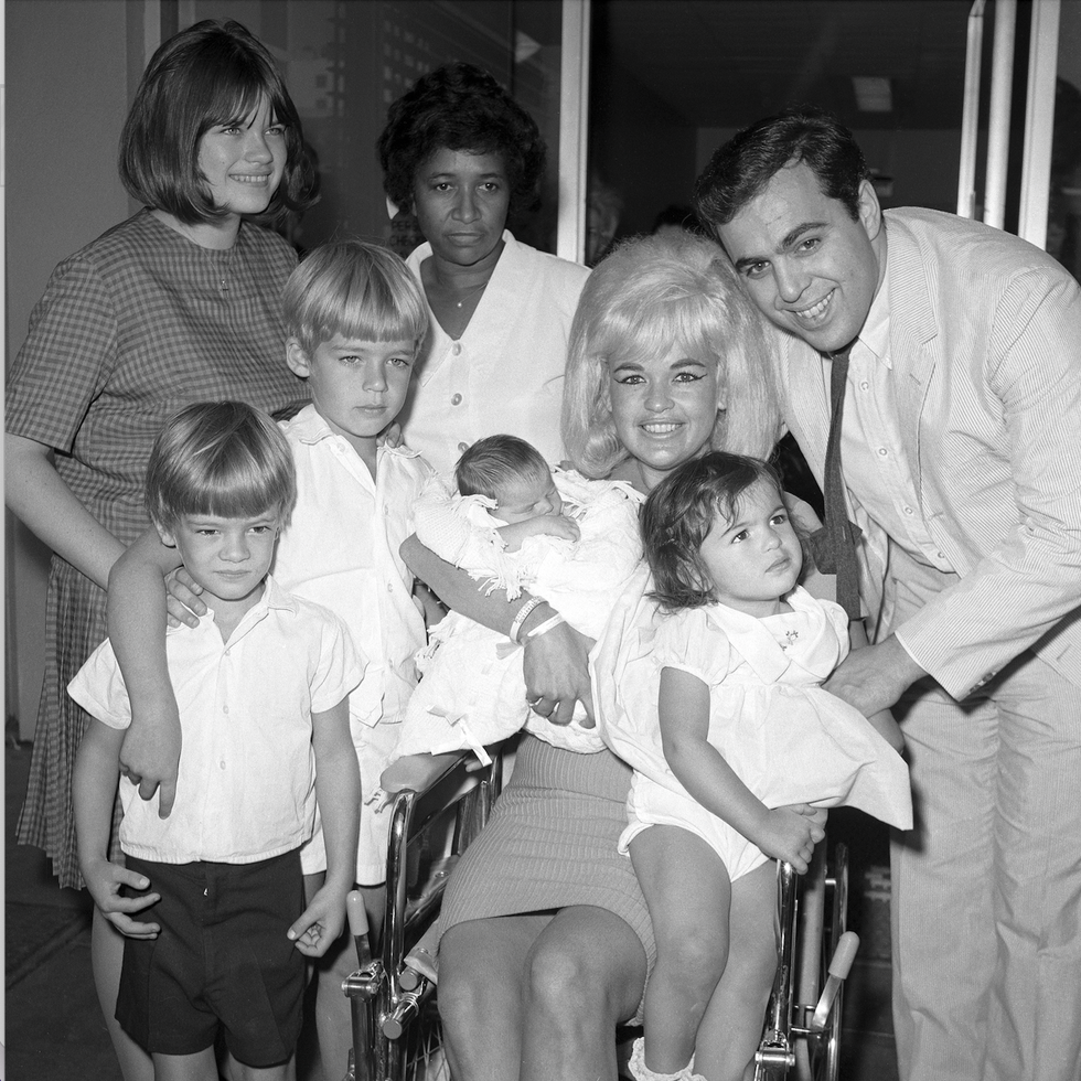 actress jayne mansfield and family are pictured here as the blonde actress leaves cedars of lebanon hospital with the newest addition to the family, baby anthony left to right are jayne marie mansfield, 15, zoltan hargitay, 5, mickey hargitay jr, 6, unidentified hospital attendant, jayne holding baby anthony, and husband matt cimber with mariska hargitay, 1