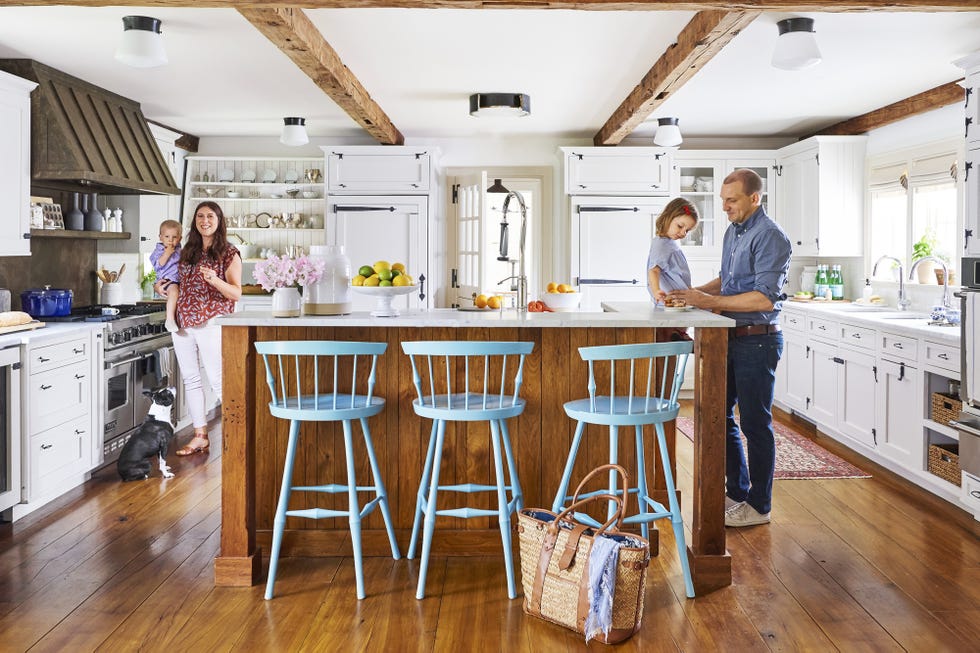 farmhouse kitchen with white cabinetry and wood beams