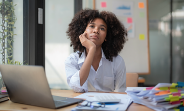 woman bored sitting at her desk