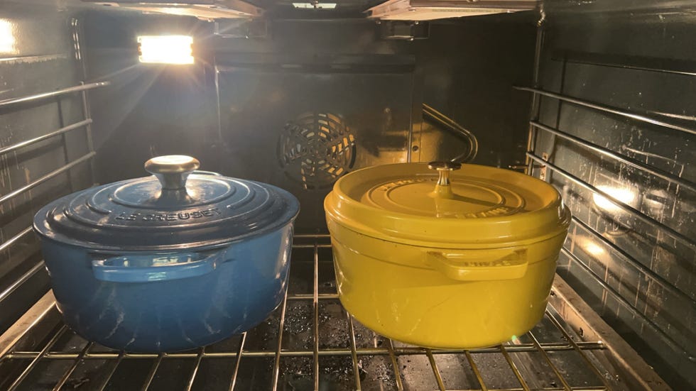 staub and le creuset dutch ovens inside of an oven