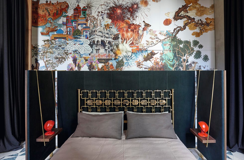 opulent bedroom with wall mural and brass bed frame