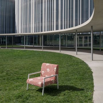 a red chair in a courtyard