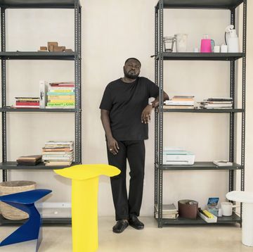 a man standing in front of a book shelf