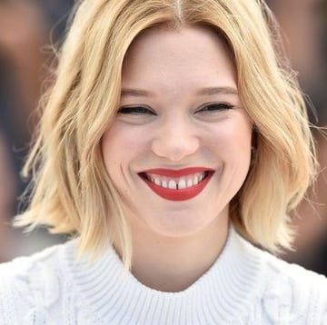 lea seydoux is een actrice met een bob en blond haar en een rode lipstick spleetje tussen tanden