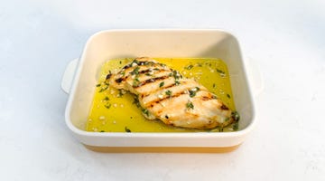 chicken breast marinating in olive oil, lemon, thyme, and garlic