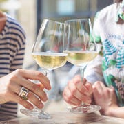 mother and adult daughter spending time together wine