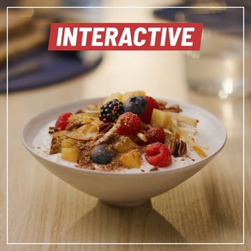 a bowl of arla skyr yogurt with mango, blueberries, raspberries and more on top