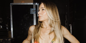 leann rimes backstage of show posing in a cut out dress with floral design