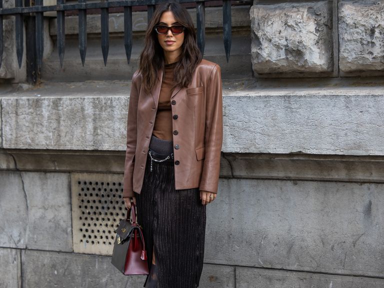 street style shot of woman in brown leather blazer