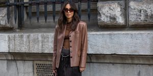 street style shot of woman in brown leather blazer