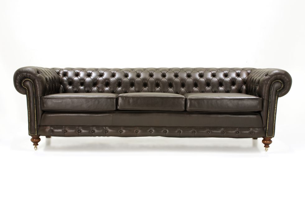 Leather couch against white background, close-up