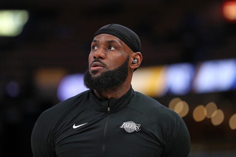 lebron james wearing a black jacket and black hat, looking up at the sky