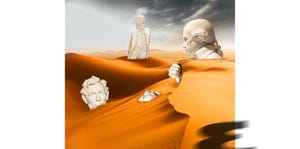 a statue of a man and a woman on a mountain