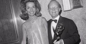 lee radziwill standing next to truman capote who is holding an emmy trophy and the both of them smiling