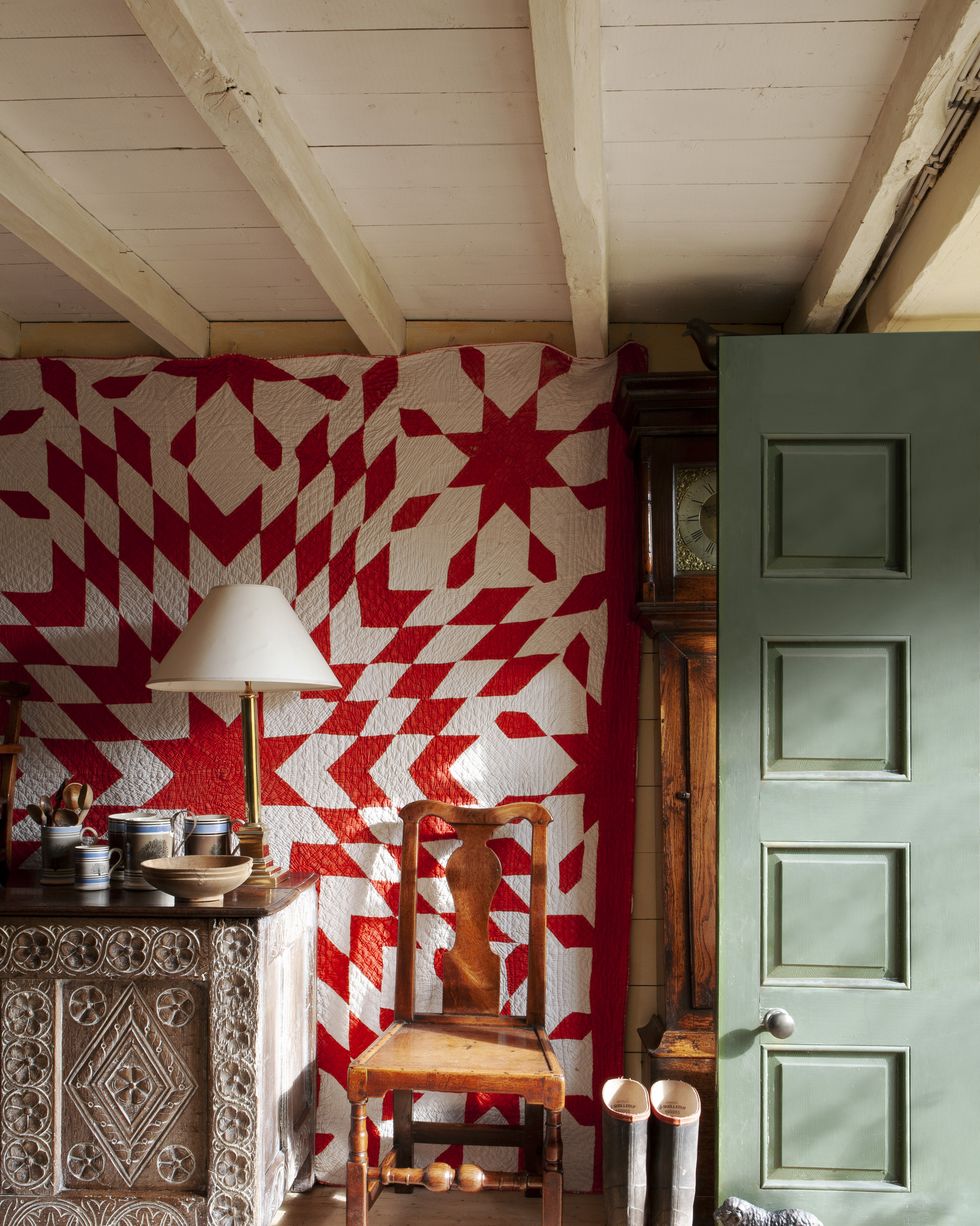 red quilt wall hanging in country cottage
