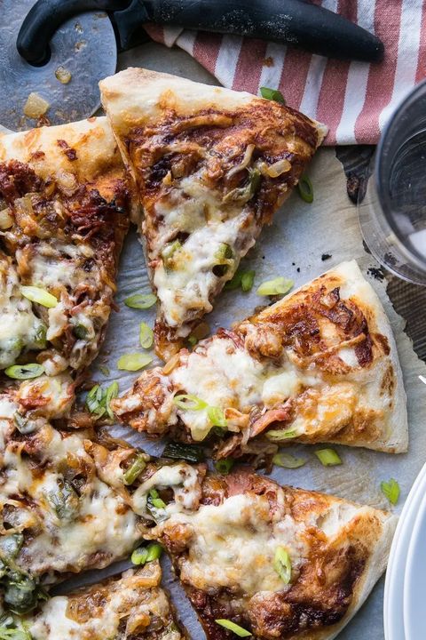 bbq pulled pork pizza with green onions on paper
