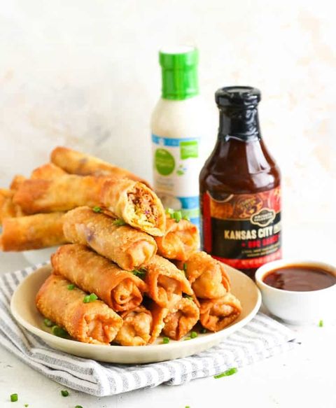 pulled pork egg rolls with jar of bbq sauce