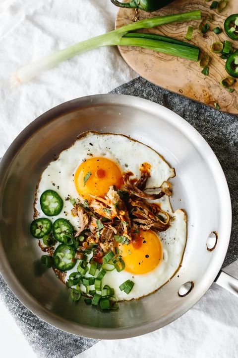 spicy pulled pork fried eggs with jalapenos in skillet