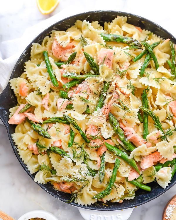 creamy asparagus and salmon pasta in skillet