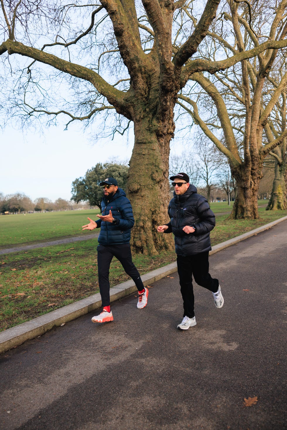 two individuals walking in a park