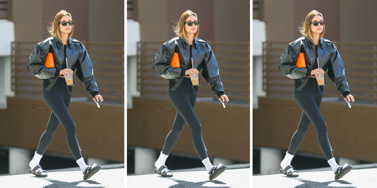 hailey bieber wears leggings and a bomber jacket to illustrate a roundup of the best leggings 2022