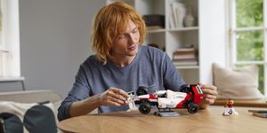 a person playing with a toy car