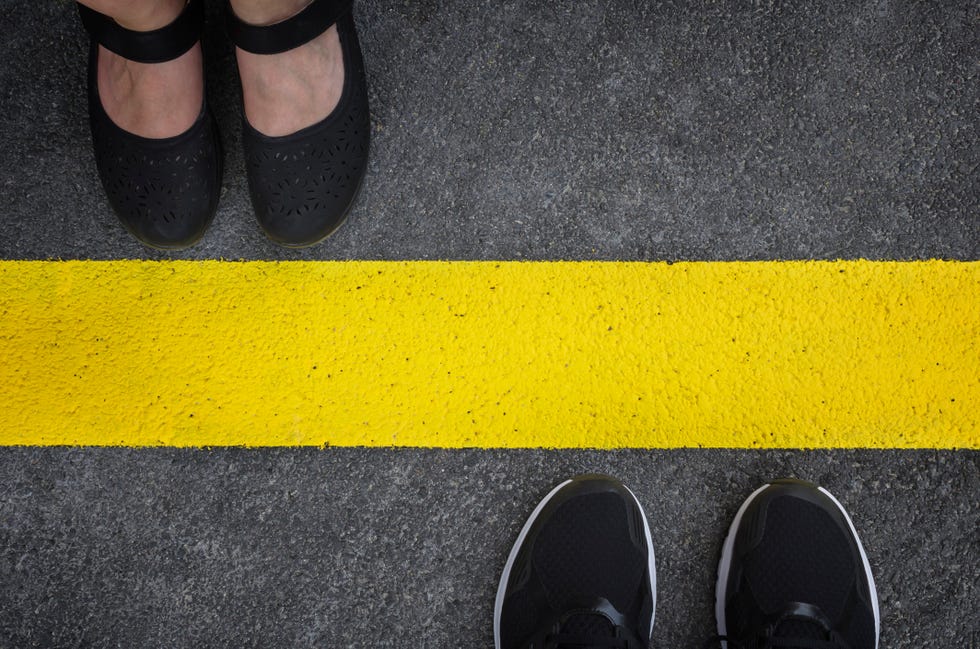 legs of a couple standing opposite each other