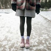 legs of caucasian woman standing in snow