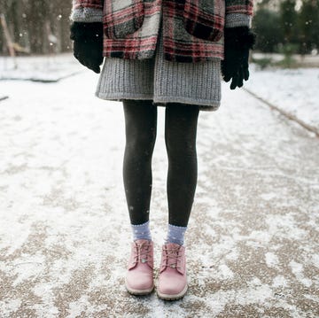 legs of caucasian woman standing in snow