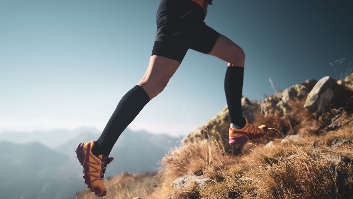 https://hips.hearstapps.com/hmg-prod/images/legs-of-cross-country-running-woman-high-up-in-royalty-free-image-1652276826.jpg?crop=1xw:0.84415xh;center,top&resize=1200:*
