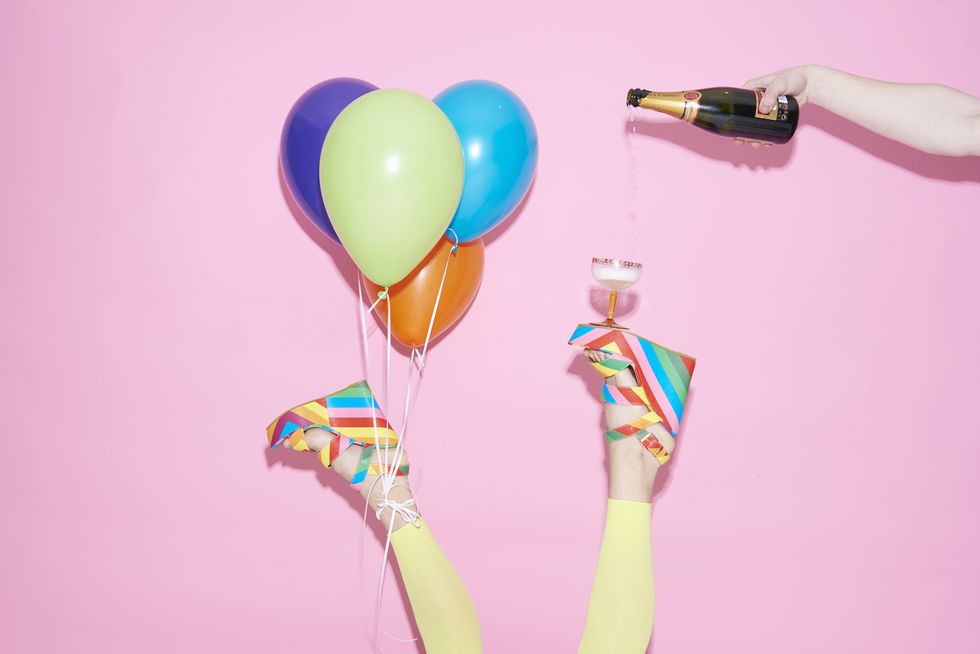 legs with champagne and balloons