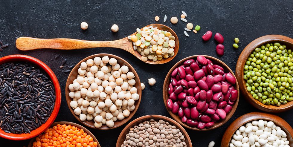 legumes, seeds and cereals on a dark background healthy food top view
