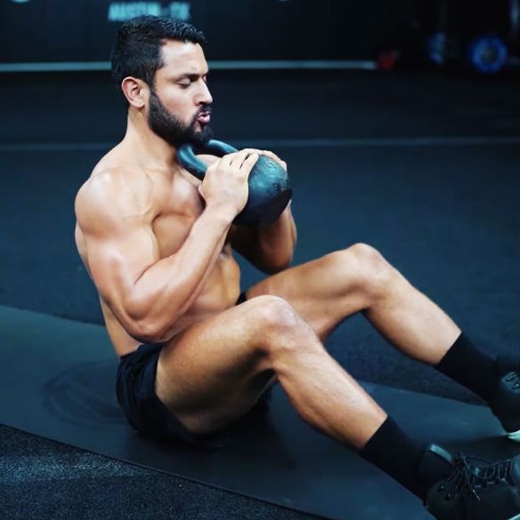 man doing crunches with a kettlebell