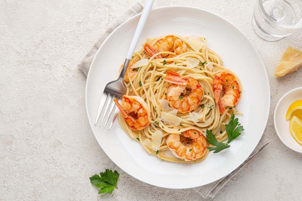 lemon and garlic shrims spaghetti pasta on white plate