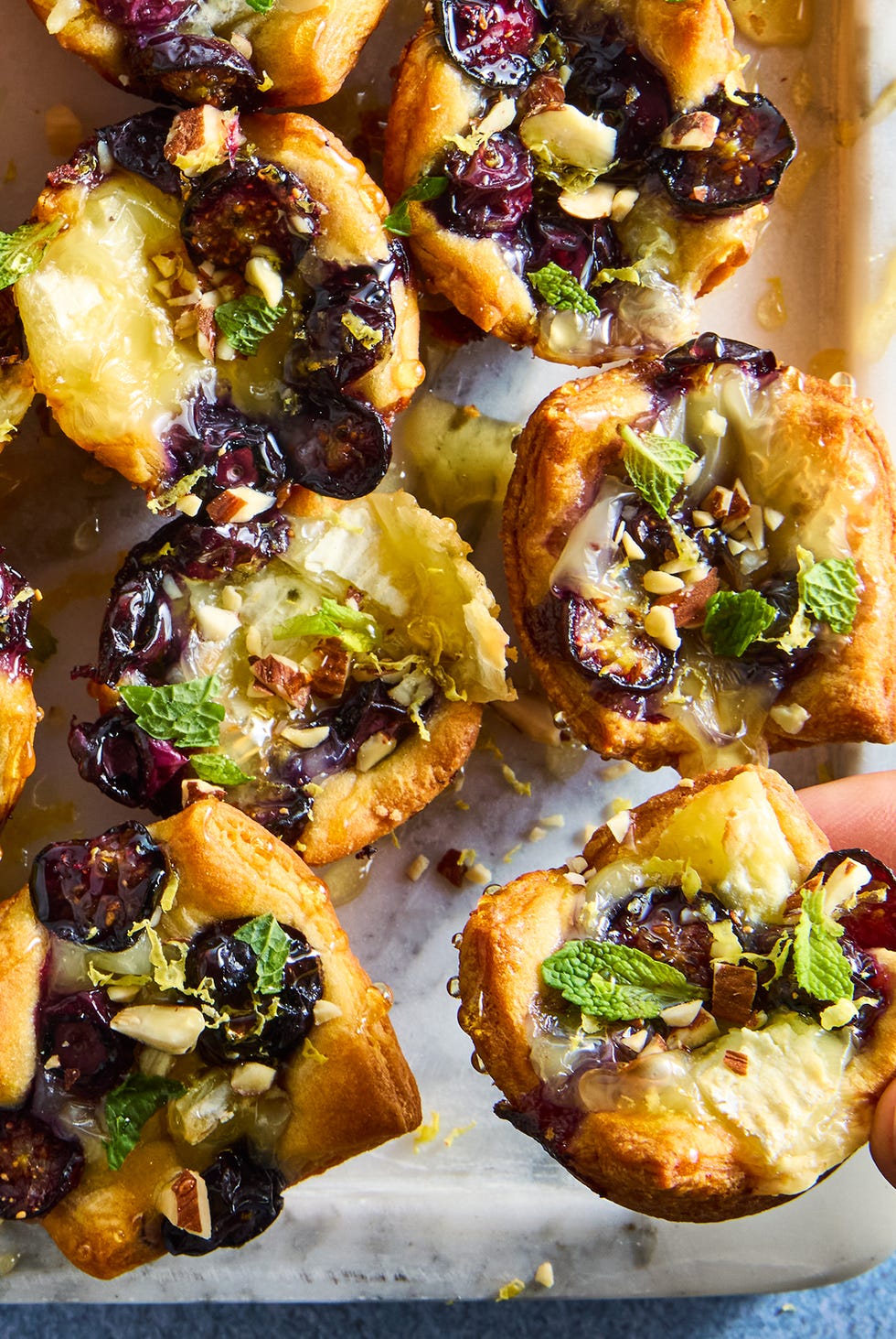Lemon Blueberry Brie Baked crescent-shaped dough filled with brie cheese, sliced blueberries, almonds and honey