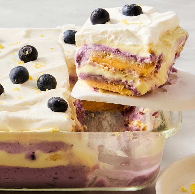 Lemon Blueberry Cheesecake Lasagna layers of lemon, blueberry, and cheesecake in a casserole dish topped with fresh blueberries