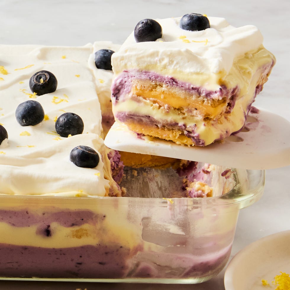 Lemon Blueberry Cheesecake Lasagna layers of lemon, blueberry, and cheesecake in a casserole dish topped with fresh blueberries