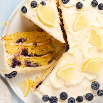 Lemon Blueberry Cake layered cake with buttercream frosting topped with lemon slices and fresh blueberries