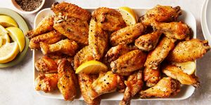 baked chicken wings tossed in a lemon pepper sauce served with lemon wedges