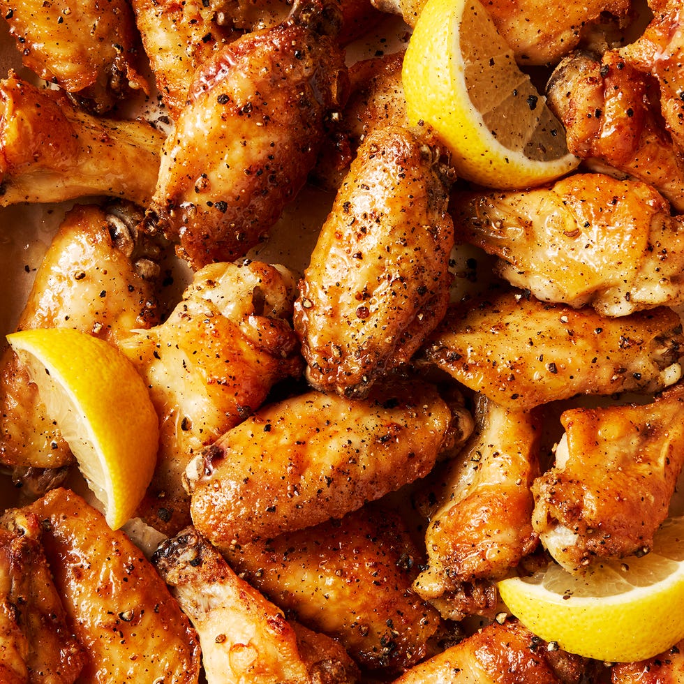baked chicken wings tossed in a lemon pepper sauce served with lemon wedges