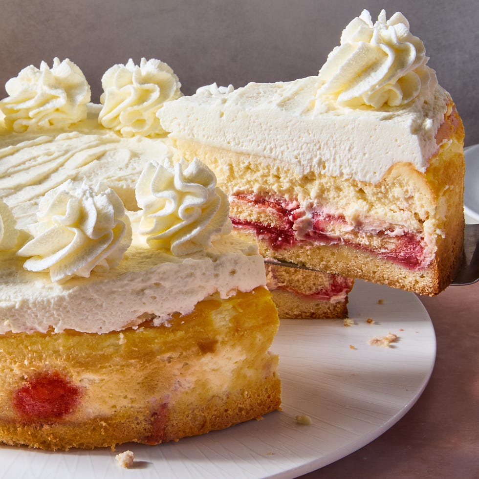 cake and cheesecake layers topped with lemon mousse, cheesecake, and raspberry syrup