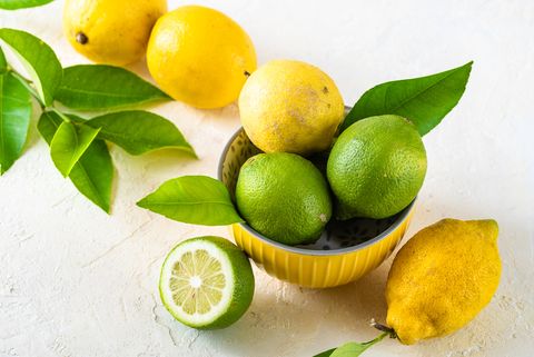 lemons and limes in a yellow bowl