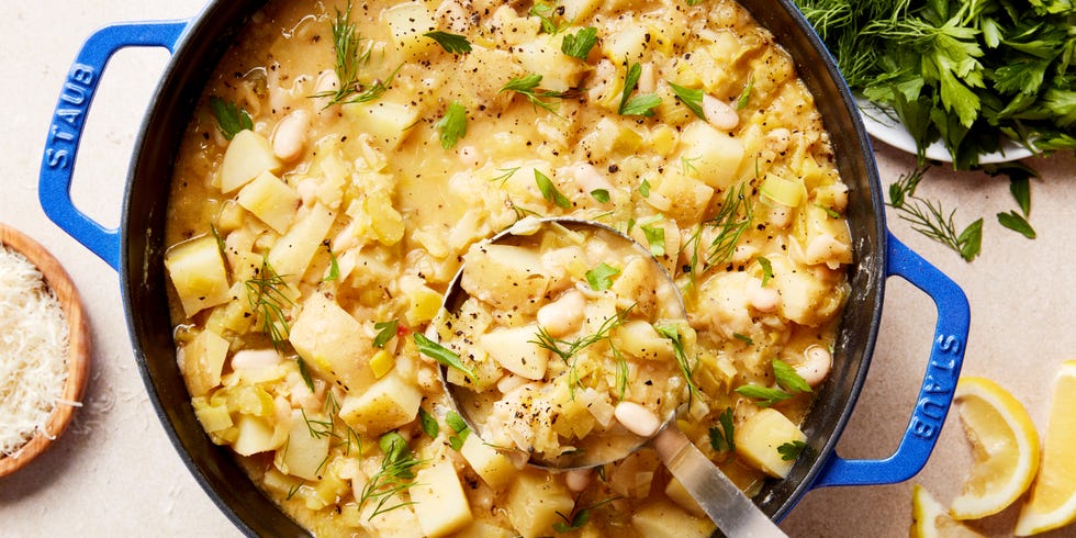 white beans and potatoes in a soup topped with parmesan