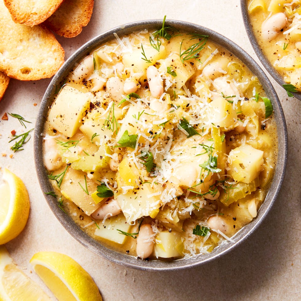 white beans and potatoes in a soup topped with parmesan