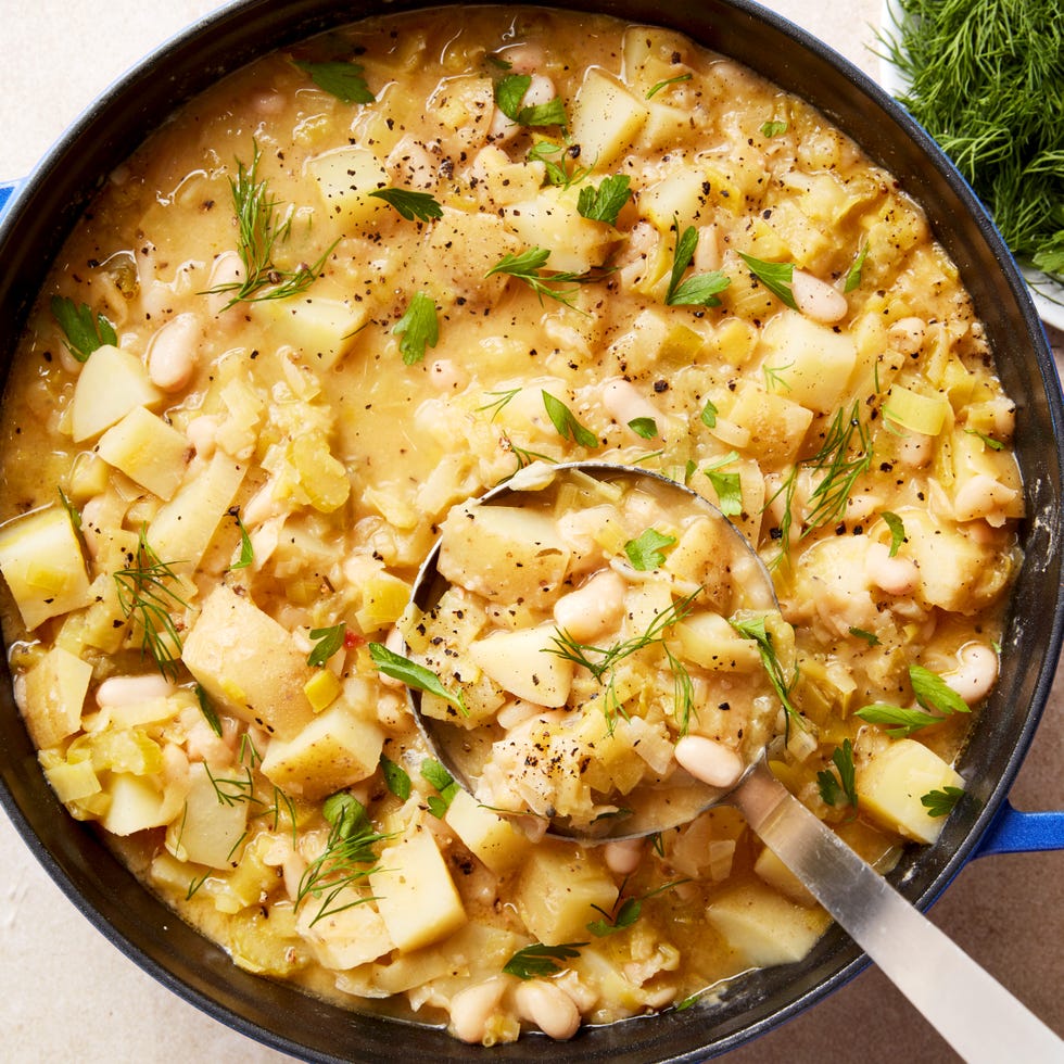 white beans and potatoes in a soup topped with parmesan