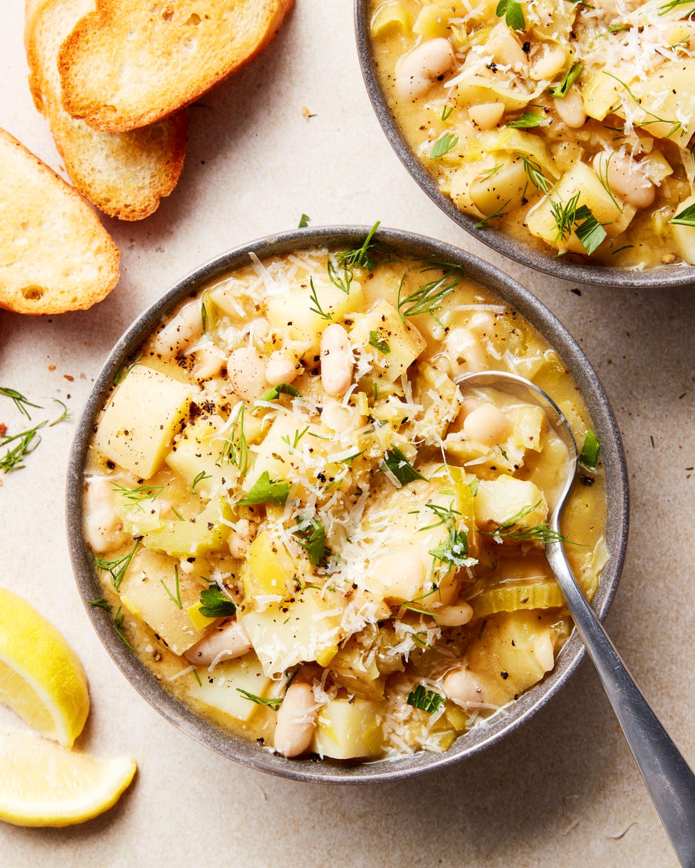 white beans and potatoes in a soup topped with parmesan