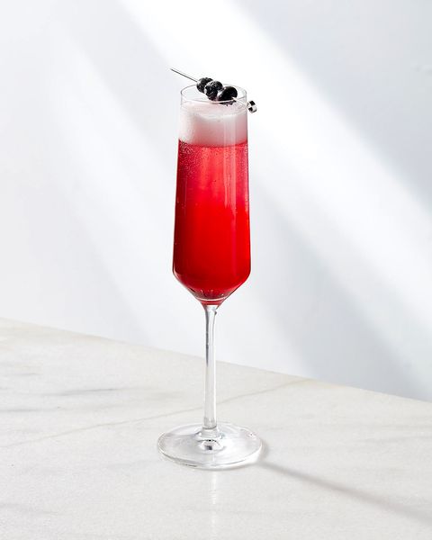 lemosa cocktail garnished with skewered blueberries