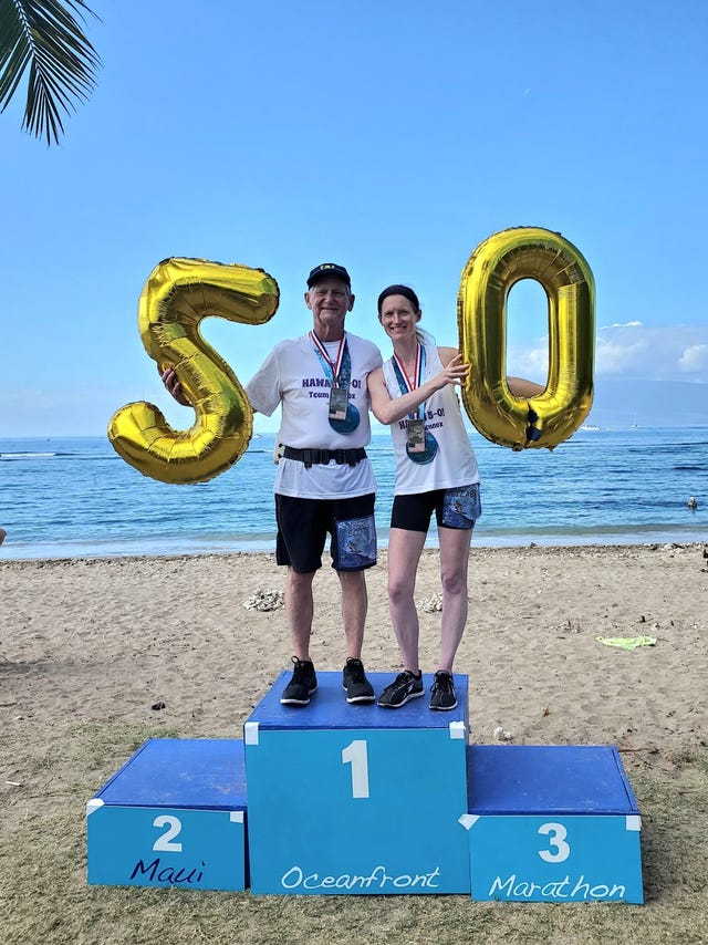 beth and scott lennox on podium at marathon finish
