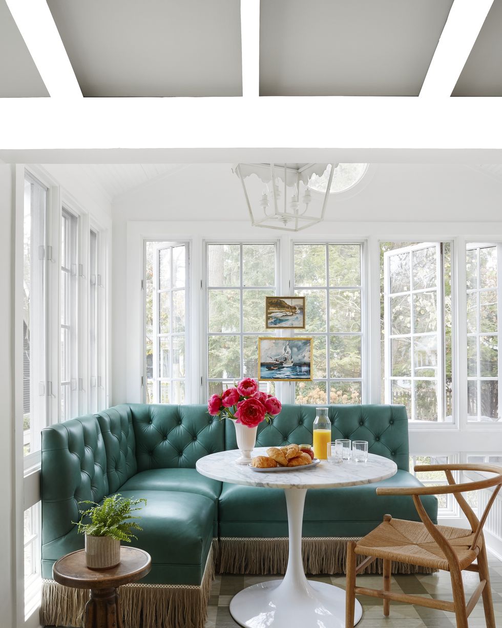 sunroom with green banquette and round table